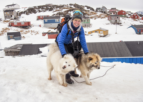 Grönland, Kulusuk, Frau mit Grönlandschlittenhunden, lizenzfreies Stockfoto