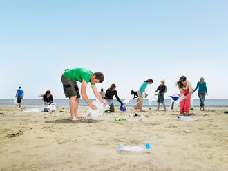Young people collecting garbage on beach - CUF00929