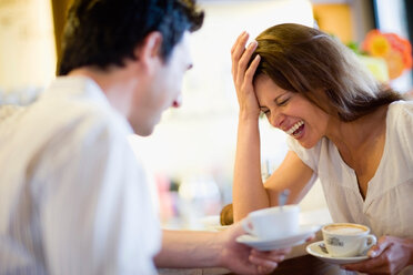 Woman laughing with man in café - CUF01041