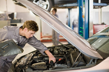 Mechanic working on car engine in garage - CUF01062