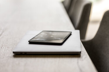 Laptop and digital tablet on table in office - FMKF05063