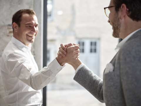 Two happy businessmen shaking hands stock photo