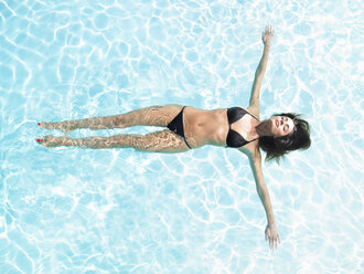 Junge Frau schwimmt im Pool - CUF01086