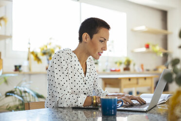 Woman using laptop on table - EBSF02550