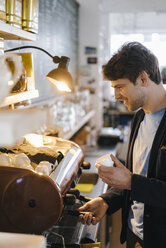 Man in a cafe preparing an espresso - KNSF03888