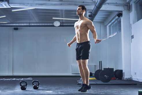 Athletischer Mann beim Seilspringen im Fitnessstudio - BSZF00327