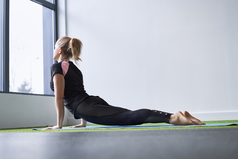 Woman doing yoga exercise in studio stock photo