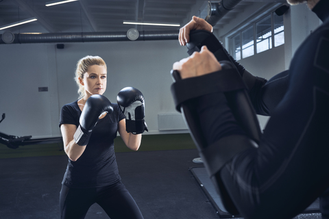 Woman practicing boxing at gym stock photo