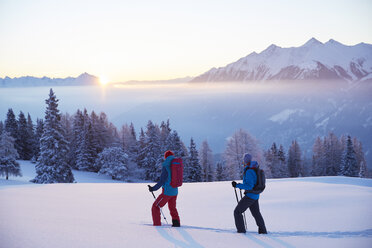 Austria, Tyrol, snowshoe hikers at sunrise - CVF00403