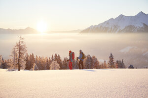 Austria, Tyrol, snowshoe hikers at sunrise - CVF00406