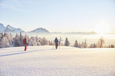 Austria, Tyrol, snowshoe hikers at sunrise - CVF00408