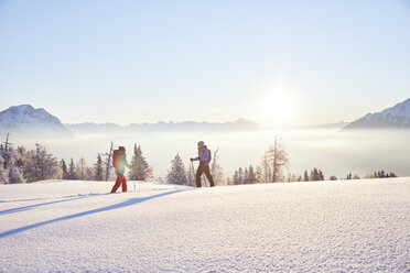 Austria, Tyrol, snowshoe hikers at sunrise - CVF00409