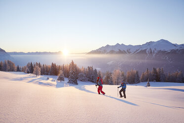 Austria, Tyrol, snowshoe hikers at sunrise - CVF00410