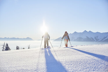 Austria, Tyrol, snowshoe hikers at sunrise - CVF00413