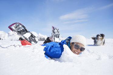 Austria, Tyrol, snowshoe hiker and dog, having fun in the snow - CVF00428