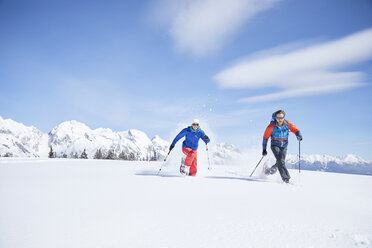 Austria, Tyrol, snowshoe hikers running through snow - CVF00430