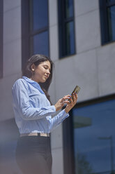 Content young businesswoman using cell phone - BEF00031