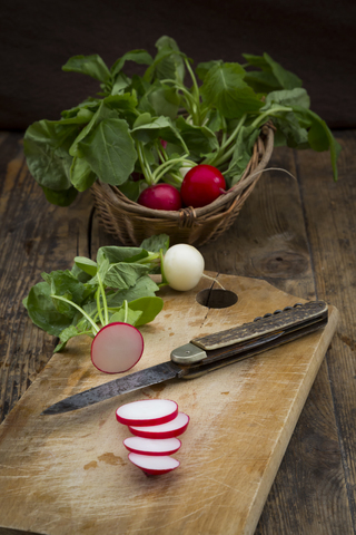 Red and white radish on chopping board stock photo