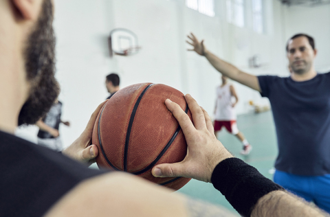 Man with basketball, indoor stock photo