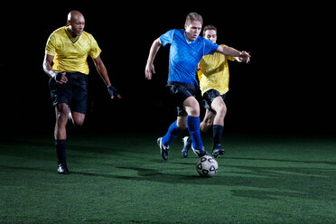 Soccer players tackling on pitch - ISF00079