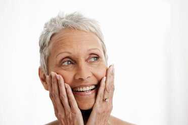 Senior woman smiling against white background - ISF00080