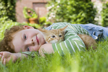 A boy holding a kitten - ISF00098