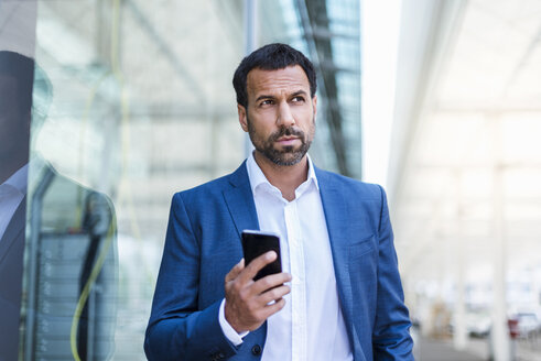 Businessman holding smartphone - DIGF04191