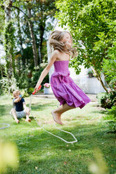 Girl jumping rope in garden - CUF01134