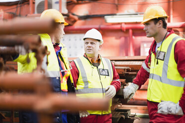 Workers talking on oil rig - CUF01143