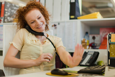 Businesswoman talking on phone at desk - CUF01192