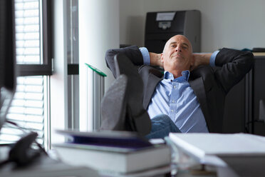 Businessman relaxing with feet on desk - CUF01320