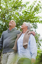 Older couple walking together outdoors - CUF01363