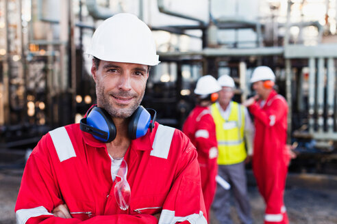 Worker standing at chemical plant - CUF01390