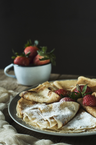 Homemade pancakes with strawberries and icing sugar stock photo