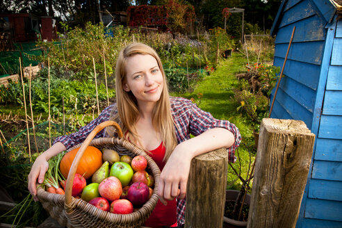 Woman gathering vegetables in garden - CUF01505