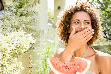 Smiling woman eating watermelon - CUF01540