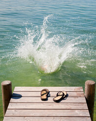 Flip flops on wooden deck by lake - CUF01608