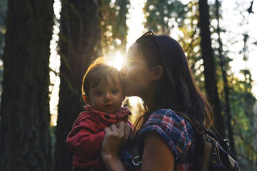 USA, California, Sequoia National Park, woman kissing her little daughter at sunset - GEMF01931