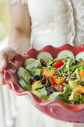 Mid adult woman holding salad bowl - ISF00439