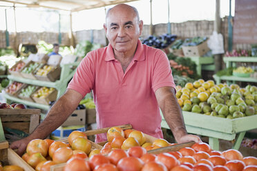 Market trader with tomatoes - ISF00597