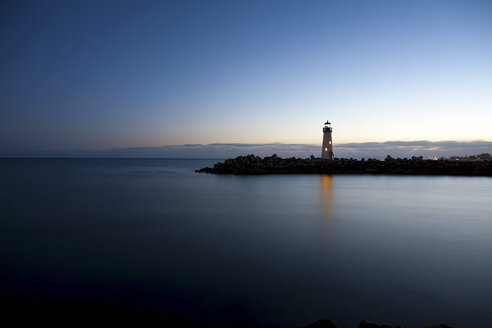 Leuchtturm mit Blick auf ruhiges Wasser in der Abenddämmerung - ISF00623