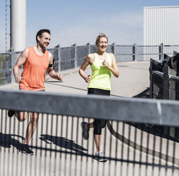 Fit couple jogging in the city - UUF13578