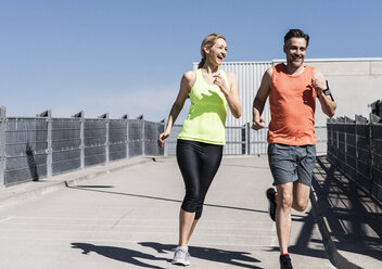 Fit couple jogging in the city - UUF13579