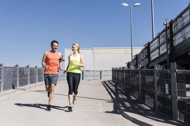 Fit couple jogging in the city - UUF13580