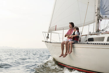 Father and son sitting on yacht - ISF00708