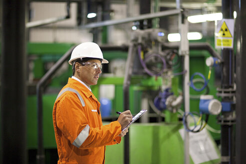 Ingenieur, der Maschinen in einer Fabrik inspiziert - ISF00709
