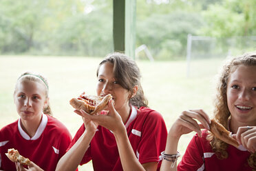 Girl soccer players eating pizza - ISF00711