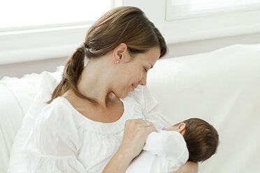 Mother breast feeding baby - ISF00764