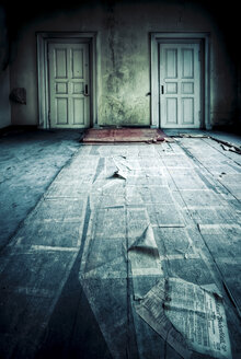 Abandoned room with two doors and newspaper on floor - ISF00782