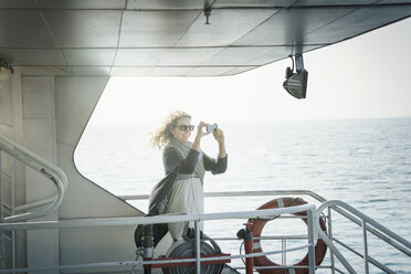 Woman on ferry taking photograph - CUF01889